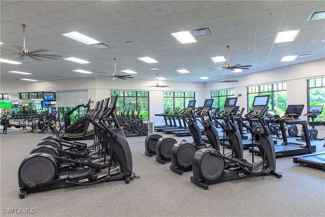 exercise room with a paneled ceiling and visible vents