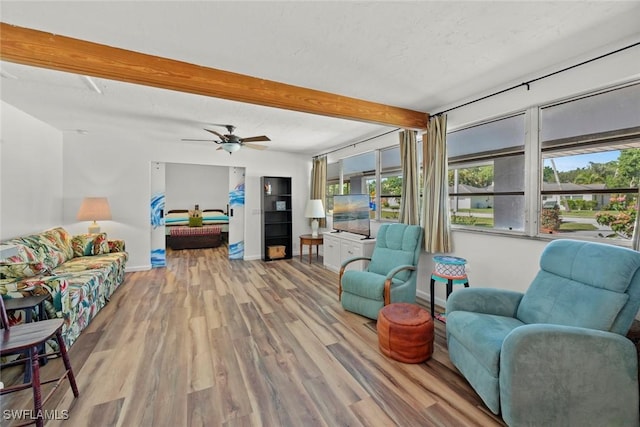 living room featuring a textured ceiling, wood finished floors, beam ceiling, and baseboards