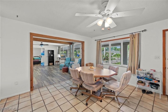 dining area with light tile patterned floors and a ceiling fan