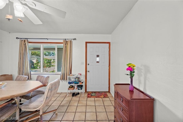 dining area with light tile patterned floors, ceiling fan, and lofted ceiling