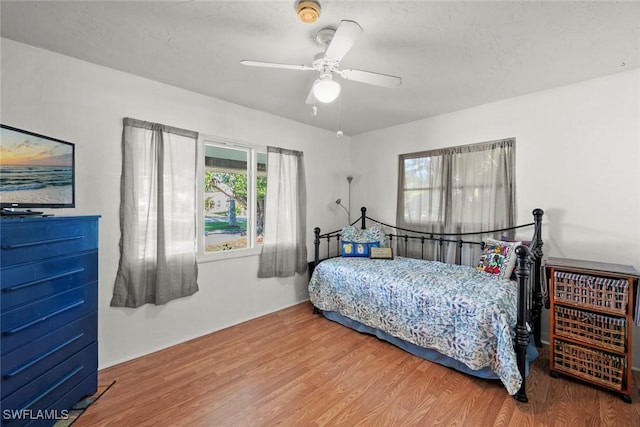 bedroom featuring wood finished floors and a ceiling fan