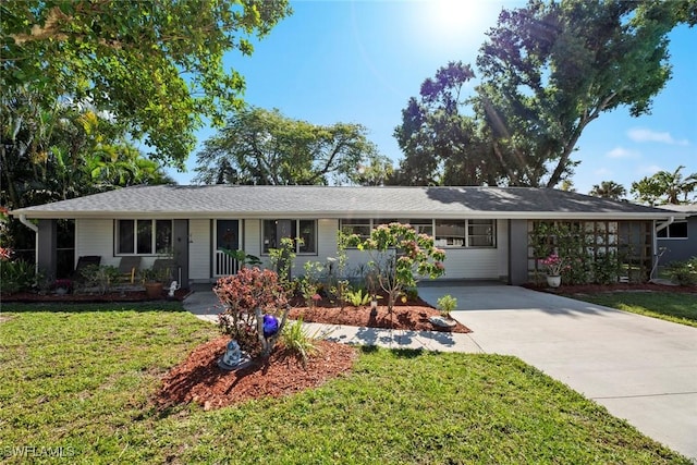 ranch-style home with a front yard and driveway