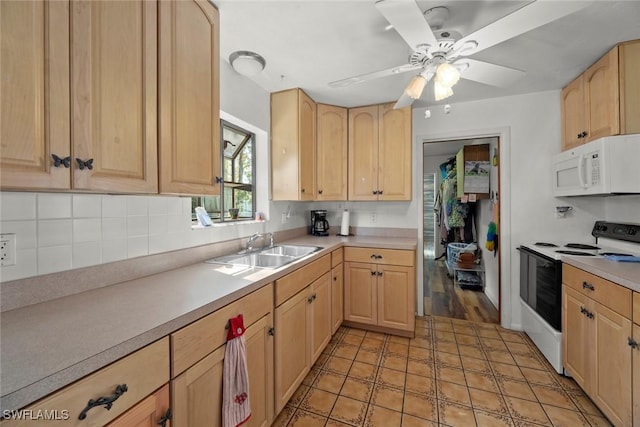 kitchen with white microwave, range with electric cooktop, a sink, and light brown cabinetry