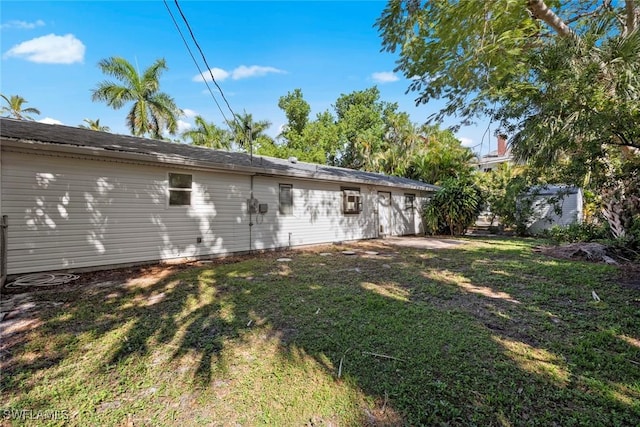 rear view of property featuring a yard