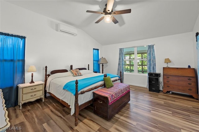 bedroom with lofted ceiling, an AC wall unit, ceiling fan, and wood finished floors