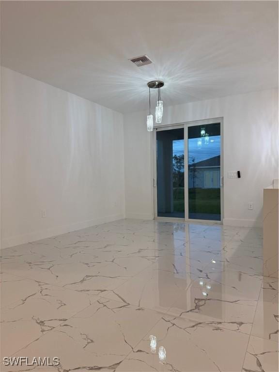 empty room featuring marble finish floor, baseboards, and visible vents