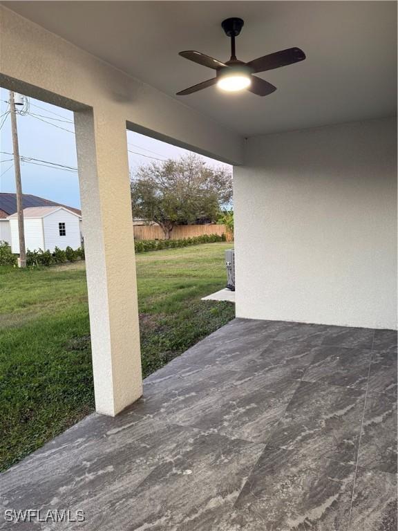 view of patio / terrace with fence and a ceiling fan