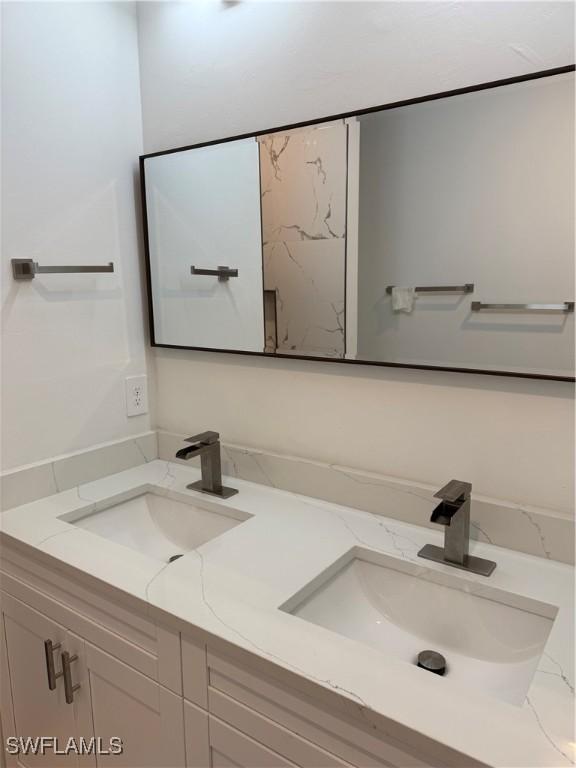 full bath with double vanity and a sink