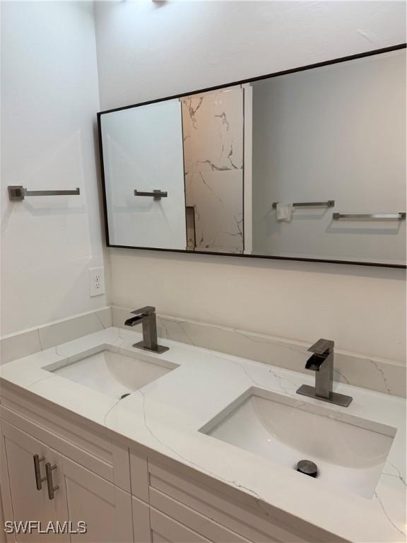 bathroom with double vanity and a sink