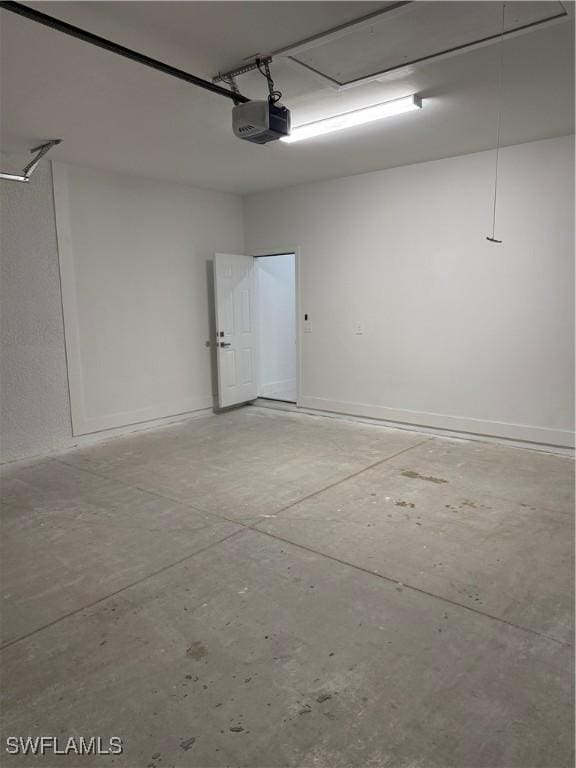 garage with baseboards and a garage door opener