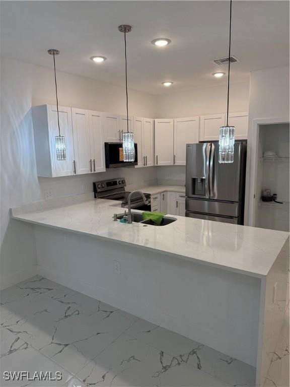 kitchen featuring light countertops, a peninsula, and stainless steel fridge with ice dispenser