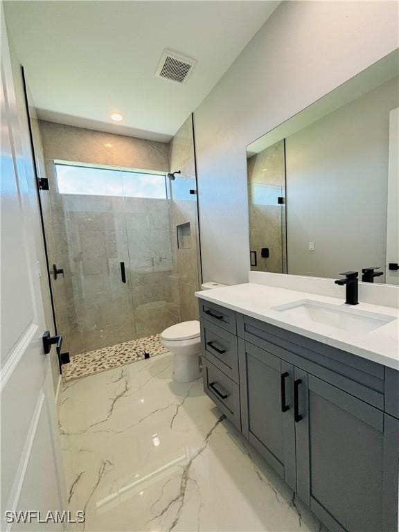 bathroom with marble finish floor, visible vents, toilet, a shower stall, and vanity