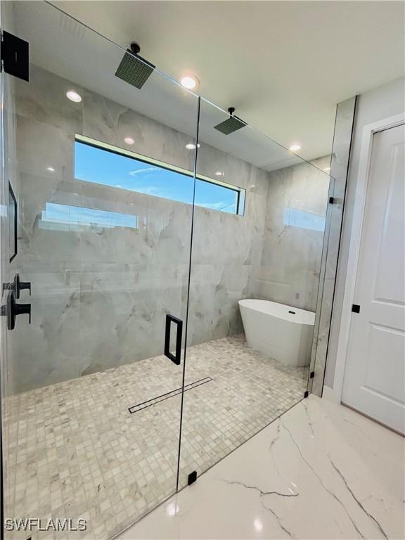 bathroom featuring recessed lighting, a soaking tub, marble finish floor, and a marble finish shower