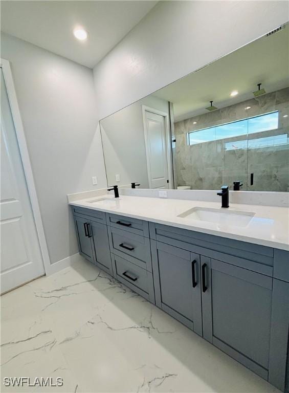 full bathroom featuring marble finish floor, a sink, a marble finish shower, and double vanity