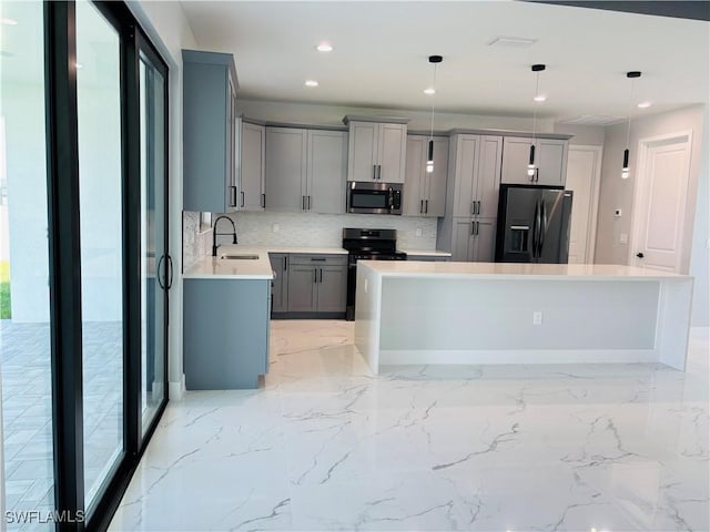 kitchen with gray cabinetry, stove, a sink, black fridge with ice dispenser, and stainless steel microwave