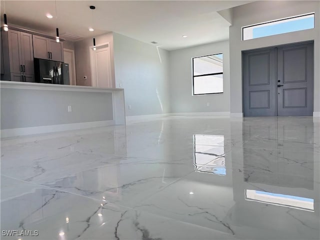 entryway with marble finish floor and recessed lighting