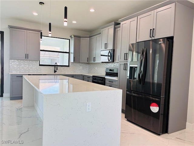 kitchen with appliances with stainless steel finishes, marble finish floor, a sink, and gray cabinetry