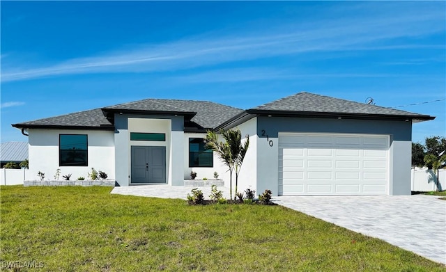 view of front of home with a garage, a front lawn, decorative driveway, and stucco siding