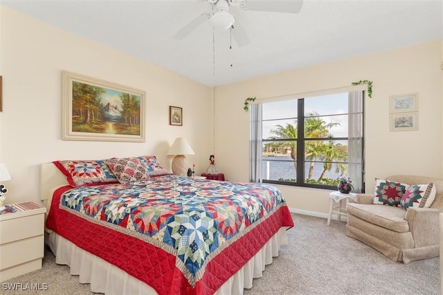 bedroom featuring baseboards, ceiling fan, and light colored carpet