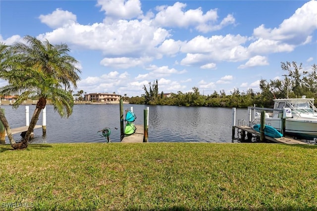 view of dock with a water view, boat lift, and a lawn