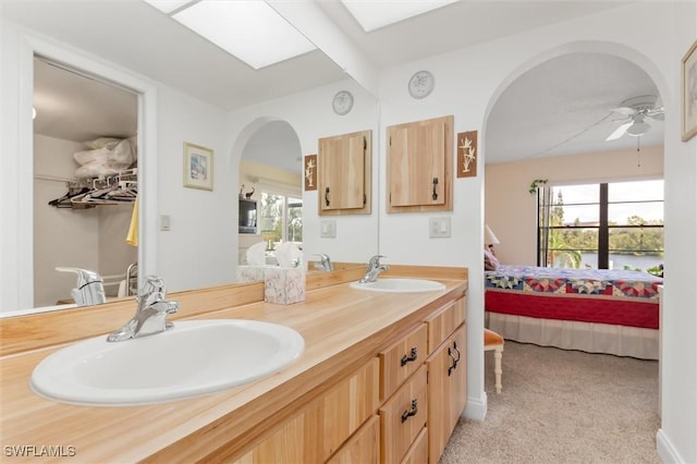 full bath with a sink, plenty of natural light, and connected bathroom