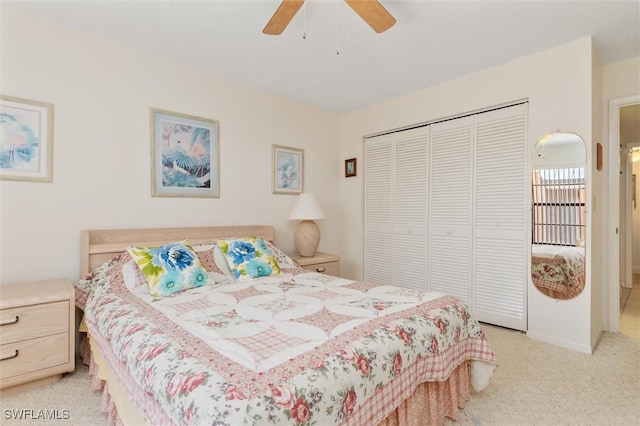 bedroom featuring a ceiling fan, a closet, and light carpet