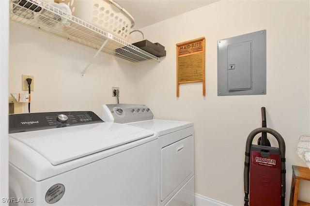 clothes washing area featuring laundry area, electric panel, and washing machine and clothes dryer