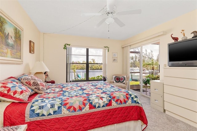 carpeted bedroom featuring access to exterior and ceiling fan