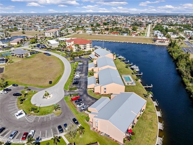 drone / aerial view featuring a water view and a residential view