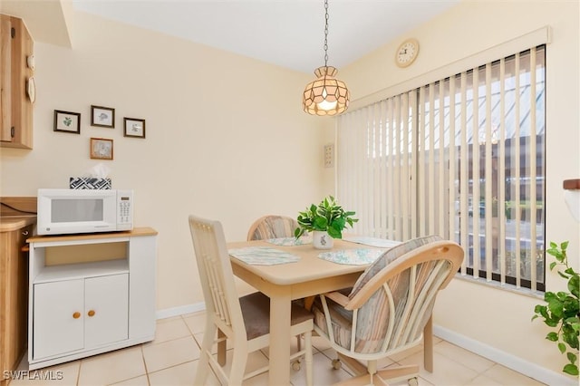 dining room featuring light tile patterned floors and baseboards