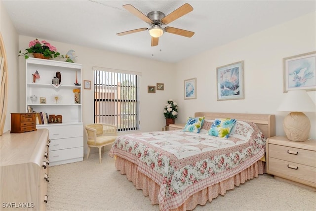 bedroom with light carpet and a ceiling fan