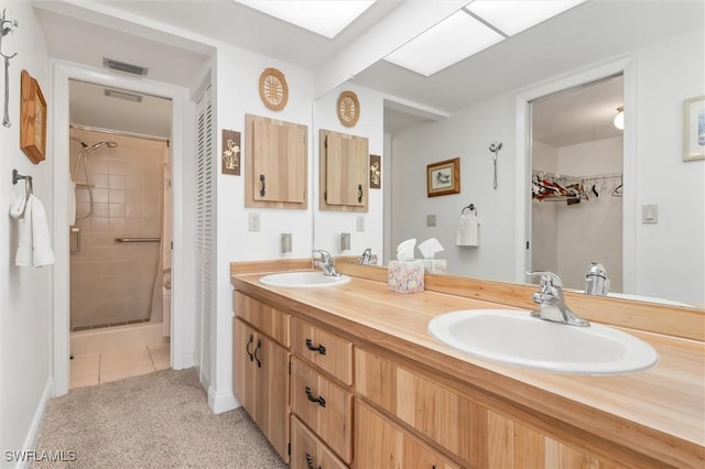 bathroom featuring double vanity, a sink, visible vents, and a shower stall