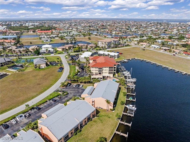 drone / aerial view featuring a water view and a residential view