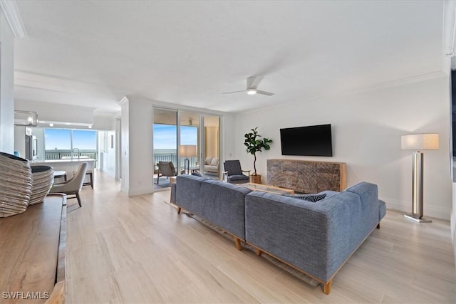 980 Cape Marco Dr Unit 805, Marco Island, FL 34145 - living room with ceiling fan, light wood-style floors, expansive windows, baseboards, and ornamental molding