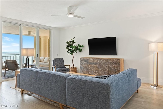 980 Cape Marco Dr Unit 805, Marco Island, FL 34145 - living room featuring crown molding, light wood-style floors, ceiling fan, a wall of windows, and baseboards