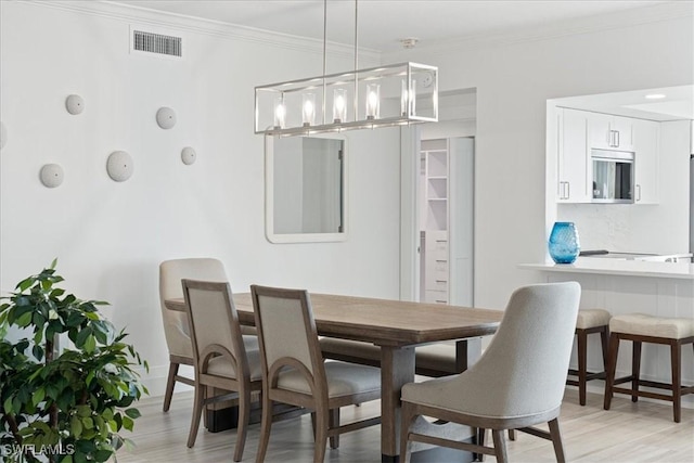 980 Cape Marco Dr Unit 805, Marco Island, FL 34145 - dining space featuring ornamental molding, light wood-style flooring, a chandelier, and baseboards