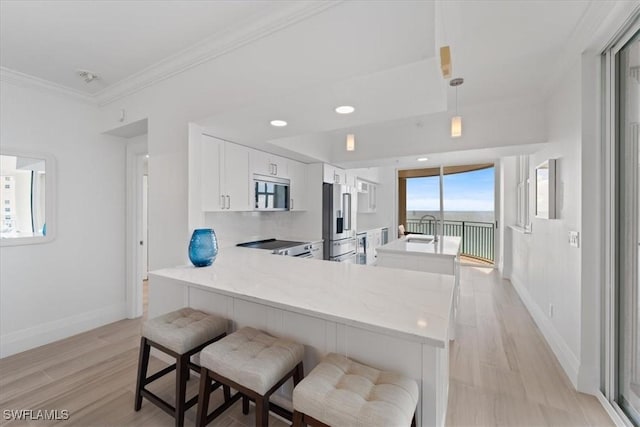 980 Cape Marco Dr Unit 805, Marco Island, FL 34145 - kitchen featuring appliances with stainless steel finishes, baseboards, light countertops, crown molding, and a peninsula