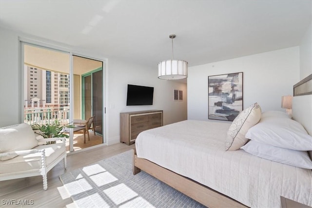 980 Cape Marco Dr Unit 805, Marco Island, FL 34145 - bedroom featuring expansive windows, light wood-style floors, and access to exterior