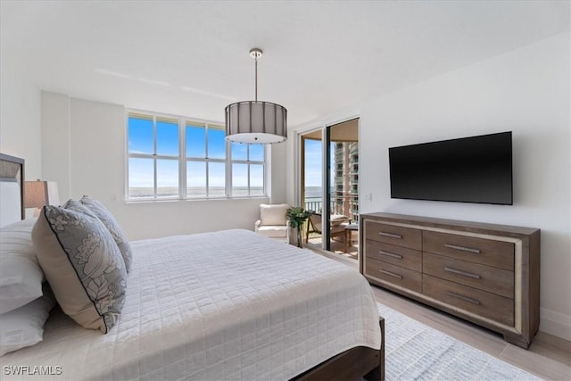 980 Cape Marco Dr Unit 805, Marco Island, FL 34145 - bedroom featuring multiple windows, access to exterior, and baseboards