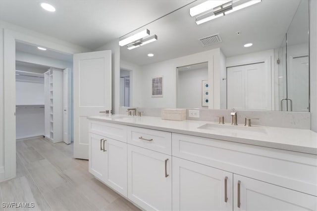 980 Cape Marco Dr Unit 805, Marco Island, FL 34145 - bathroom featuring a closet, recessed lighting, double vanity, a stall shower, and wood finished floors