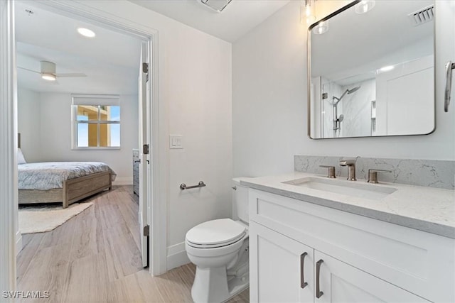 980 Cape Marco Dr Unit 805, Marco Island, FL 34145 - ensuite bathroom with toilet, vanity, baseboards, wood finished floors, and a ceiling fan