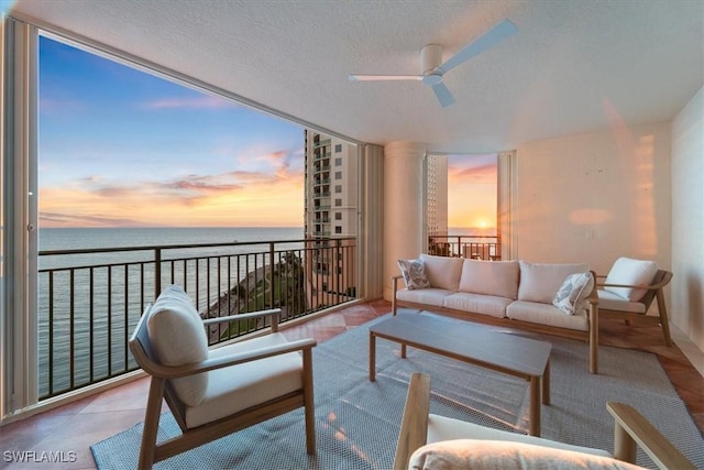 980 Cape Marco Dr Unit 805, Marco Island, FL 34145 - living area with a water view, a ceiling fan, and a textured ceiling