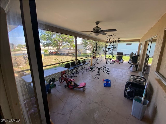 view of patio / terrace featuring a lanai and a ceiling fan