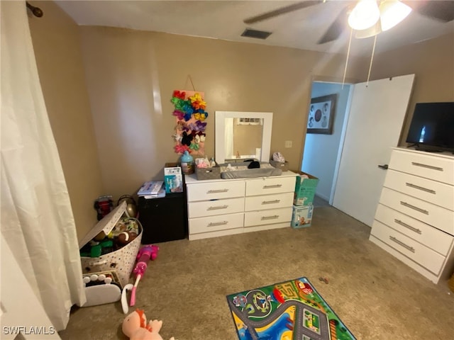 playroom featuring carpet, ceiling fan, and visible vents