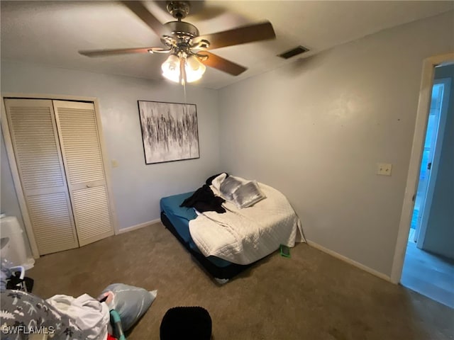 bedroom featuring baseboards, a closet, visible vents, and carpet flooring