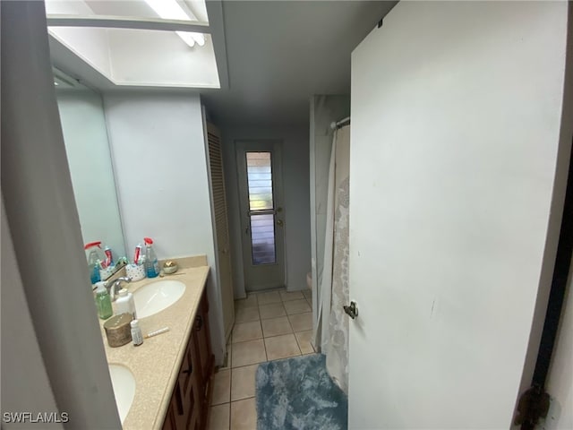 full bath featuring a sink, double vanity, curtained shower, and tile patterned flooring