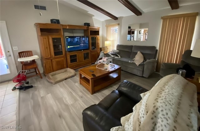 living room featuring visible vents, lofted ceiling with beams, and light tile patterned flooring