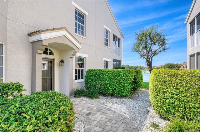 property entrance with stucco siding