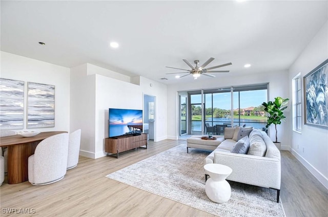 living room featuring baseboards, wood finished floors, and recessed lighting