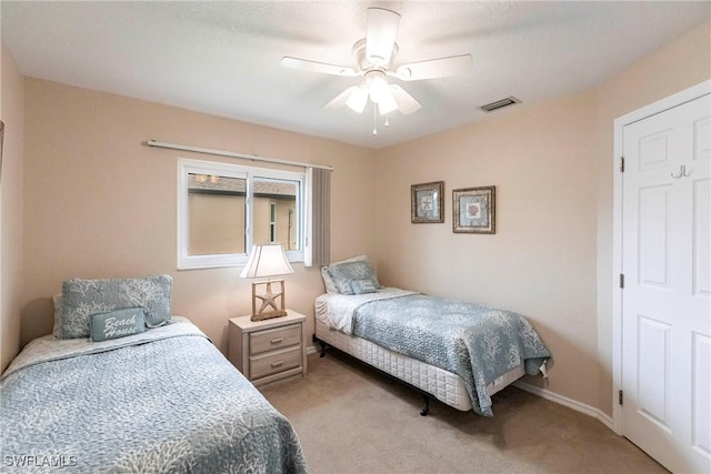 bedroom with light carpet, ceiling fan, visible vents, and baseboards